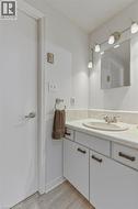 Vanity with a light-colored countertop, an undermount sink, and a two-handle faucet - 