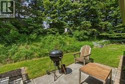 Patio area featuring concrete pavers and a bordered mulched garden bed - 