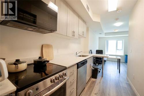 Compact kitchen featuring light wood-finish cabinetry and light-toned countertops - 246 Lester Street Unit# 306, Waterloo, ON 