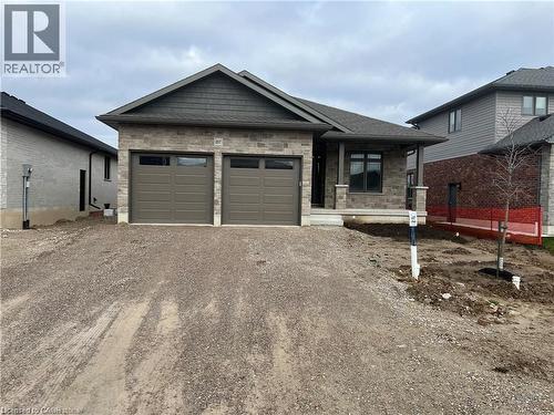 View of front of property with dirt driveway and an attached garage - 207 Arden Crescent Unit# Upper Level, Mitchell, ON 