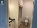 Bathroom with vanity, wood finished floors, toilet, baseboards, and shower / tub combination - 207 Arden Crescent Unit# Upper Level, Mitchell, ON 