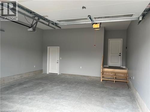 Garage featuring a garage door opener - 207 Arden Crescent Unit# Upper Level, Mitchell, ON 