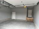 Garage featuring a garage door opener - 207 Arden Crescent Unit# Upper Level, Mitchell, ON 
