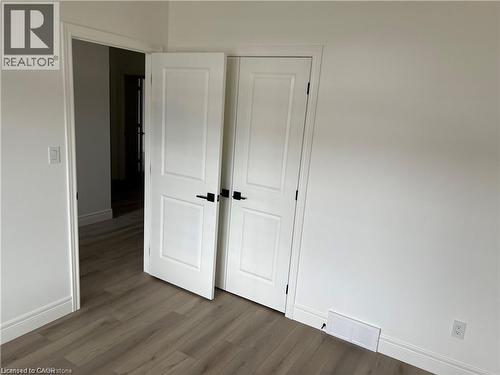 Unfurnished bedroom with baseboards, wood finished floors, and a closet - 207 Arden Crescent Unit# Upper Level, Mitchell, ON 