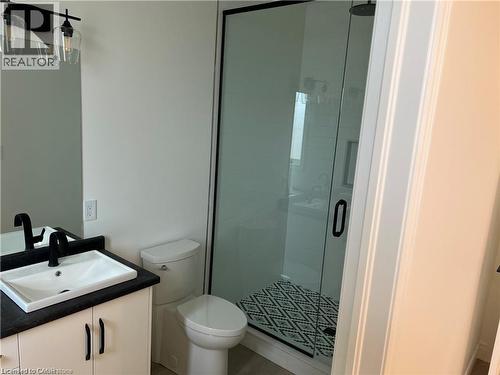 Full bath featuring vanity, a stall shower, and toilet - 207 Arden Crescent Unit# Upper Level, Mitchell, ON 