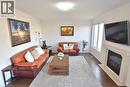 Living room featuring dark wood finished floors and a fireplace with flush hearth - 512 Terrington Crescent, Kitchener, ON 