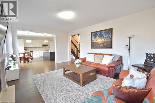 Living room with stairs and dark wood-style flooring - 512 Terrington Crescent, Kitchener, ON 