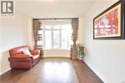 Sitting room with hardwood / wood-style flooring and baseboards - 512 Terrington Crescent, Kitchener, ON 