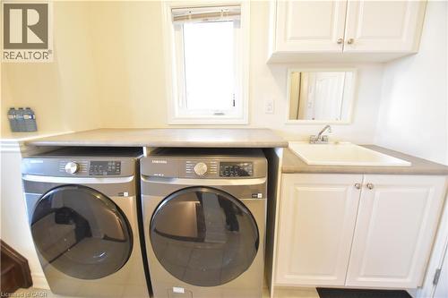 Laundry room with a sink and washing machine and dryer - 512 Terrington Crescent, Kitchener, ON 