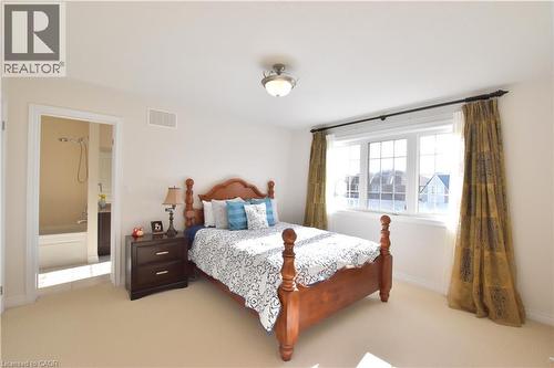 Bedroom with light colored carpet and ensuite bath - 512 Terrington Crescent, Kitchener, ON 