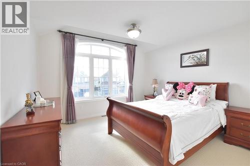 Bedroom with light colored carpet and baseboards - 512 Terrington Crescent, Kitchener, ON 