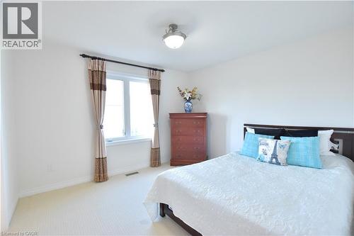 Bedroom with light carpet and baseboards - 512 Terrington Crescent, Kitchener, ON 