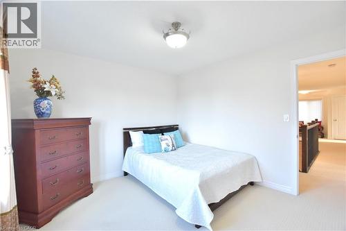 Bedroom featuring light colored carpet and baseboards - 512 Terrington Crescent, Kitchener, ON 