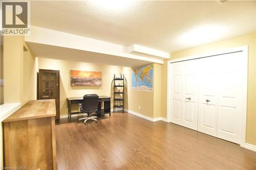 Office featuring dark wood-type flooring and a textured ceiling - 512 Terrington Crescent, Kitchener, ON 