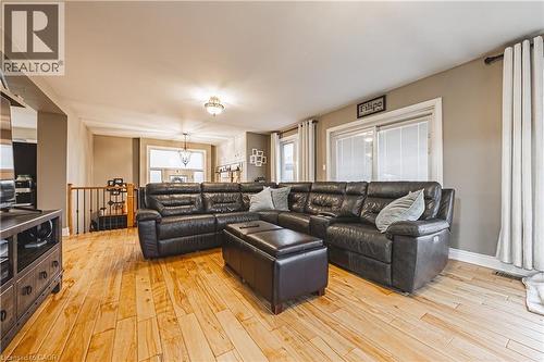 Open-concept living area featuring light wood-finish flooring, neutral wall tones, and recessed lighting - 70 Webster Road, Hamilton, ON 
