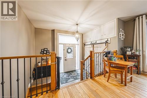 Entryway featuring a decorative glass panel door with transom window, tile flooring, and an overhead chandelier - 70 Webster Road, Hamilton, ON 