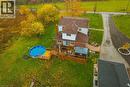 Expansive rear yard featuring a multi-level wood deck, an above-ground pool, a pergola structure, a stone patio, and mature trees - 70 Webster Road, Hamilton, ON 