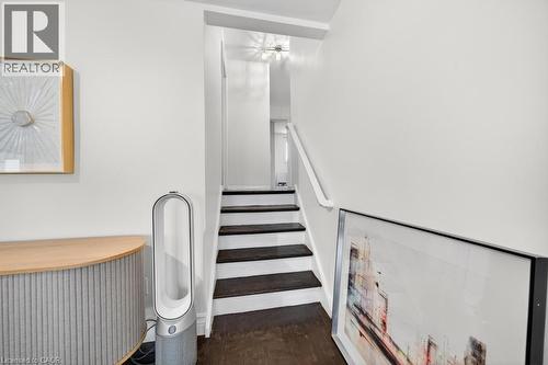 Hardwood stairs with painted risers and a white handrail - 19 Glen Forest Drive, Hamilton, ON 