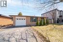 Brick exterior featuring a single-car garage with a white door and window accents - 19 Glen Forest Drive, Hamilton, ON 