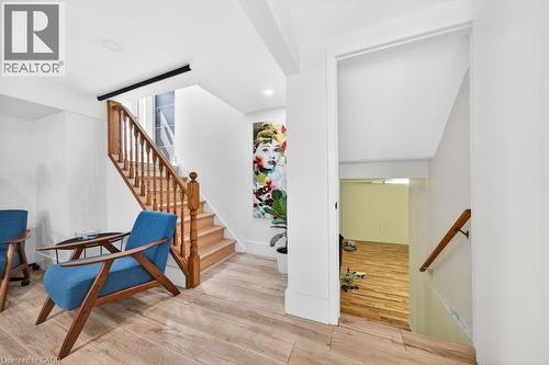 Interior staircase featuring wood balusters and handrail - 19 Glen Forest Drive, Hamilton, ON 