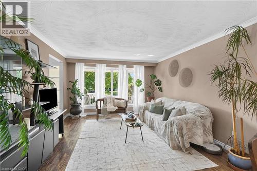 Living area featuring wood-finish flooring, light-toned walls, and white crown molding - 1083 Melton Drive, Mississauga, ON 