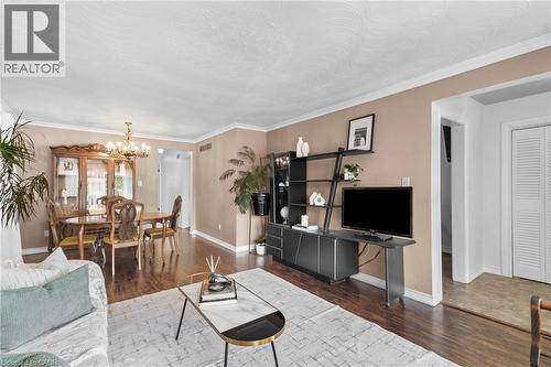Spacious living area featuring wood-finish flooring, crown molding, and neutral wall tones - 1083 Melton Drive, Mississauga, ON 