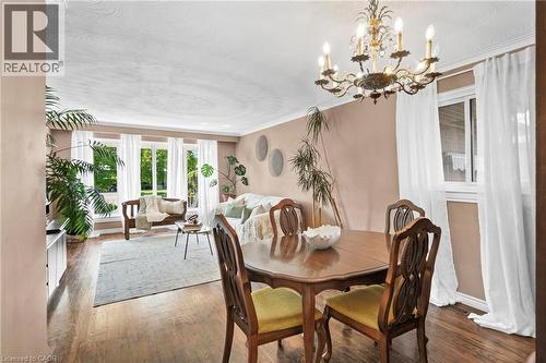 Dining area featuring a classic chandelier and wood-finish flooring - 1083 Melton Drive, Mississauga, ON 