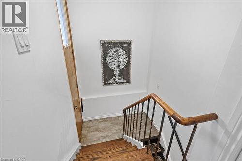 Hardwood staircase featuring dark wood treads and white risers - 1083 Melton Drive, Mississauga, ON 