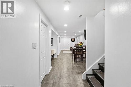 Spacious hallway featuring wood-finish flooring extending through to an open-concept living area - 1083 Melton Drive, Mississauga, ON 