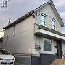 Two-story brick exterior with a gabled roofline and arched upper windows - 269 Cannon Street E, Hamilton, ON 