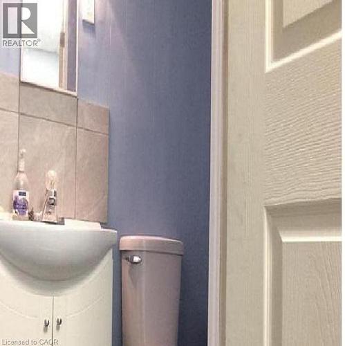 Bathroom vanity with integrated sink, chrome faucet, and mirrored medicine cabinet - 269 Cannon Street E, Hamilton, ON 