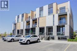 Modern townhome exteriors featuring horizontal light-toned siding, dark grey paneling, and white facade accents - 