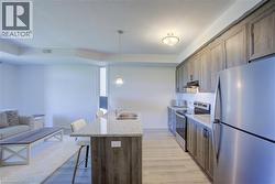 Open-concept living space featuring wood-finish flooring throughout - 