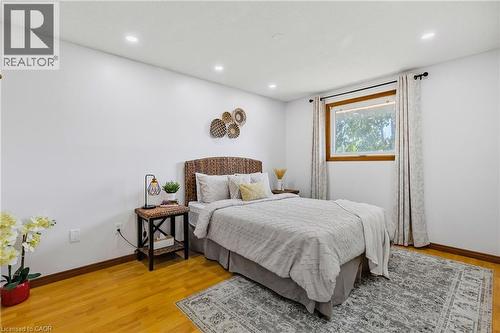 Bright room featuring a single window with wood-finish trim, recessed lighting, and wood-finish flooring - 102 Juniper Drive, Hamilton, ON 