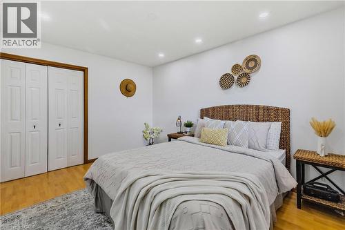 Bedroom featuring wood-finish flooring, recessed lighting, and white walls - 102 Juniper Drive, Hamilton, ON 
