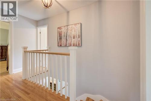 Upper landing featuring hardwood flooring and a white balustrade with a light wood-finish handrail - 314 Glasgow Street, Kitchener, ON 