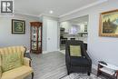 Living area featuring light wood-finish flooring and crown molding - 185 Rosslyn Avenue N, Hamilton, ON 