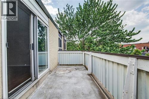 Concrete balcony featuring a light-toned brick exterior - 75 Hazelglen Drive Unit# 310, Kitchener, ON 