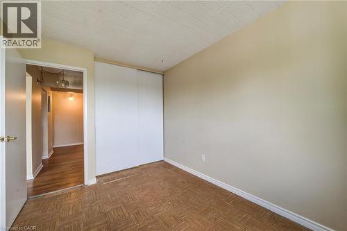Room featuring patterned flooring, light-toned walls, and white baseboards - 75 Hazelglen Drive Unit# 310, Kitchener, ON 