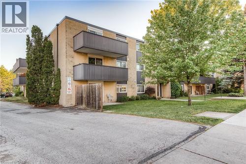 Multi-story building featuring light brick and dark paneling - 75 Hazelglen Drive Unit# 310, Kitchener, ON 