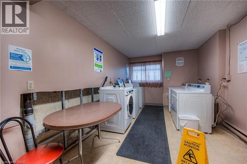 Dedicated laundry room featuring multiple washing machines and dryers - 75 Hazelglen Drive Unit# 310, Kitchener, ON 