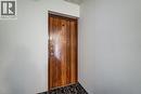 Entry door featuring a rich wood-finish panel, dark wood-finish trim, and stainless steel hardware - 75 Hazelglen Drive Unit# 310, Kitchener, ON 