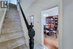 Staircase with carpeted treads and a dark wood newel post - 