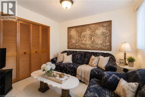 Recessed lighting illuminates the room, featuring light-toned tile flooring and a window with vertical blinds - 244 Hughson Street N, Hamilton, ON 