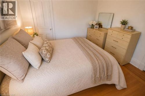 Wood-finish flooring with baseboard molding - 244 Hughson Street N, Hamilton, ON 