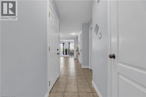 Hallway with neutral wall tones and tile flooring - 48 Clough Crescent, Guelph, ON 