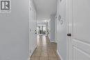 Hallway with neutral wall tones and tile flooring - 48 Clough Crescent, Guelph, ON 