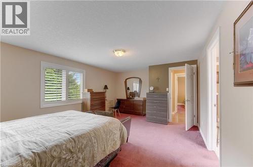 Generous interior space featuring a window with white louvered shutters, flush mount ceiling lighting, and a neutral wall color - 599 Coldstream Drive, Waterloo, ON 