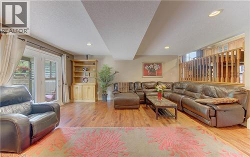 Hardwood-finish flooring throughout, recessed lighting, double French doors, and built-in cabinetry with shelving - 599 Coldstream Drive, Waterloo, ON 