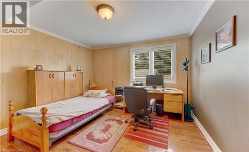 Room featuring wood-finish flooring, white crown molding, and a built-in window with horizontal blinds - 599 Coldstream Drive, Waterloo, ON 